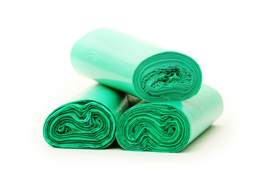 Green garbage bags rolls on a white background