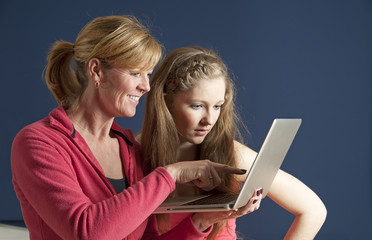 Adult and teenager looking at a laptop computer