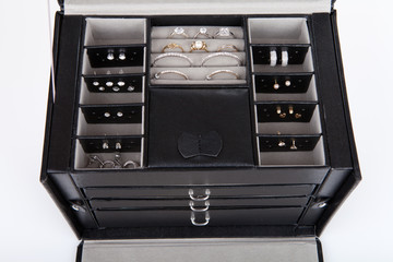 Black leather jewelery box with jewelry inside
