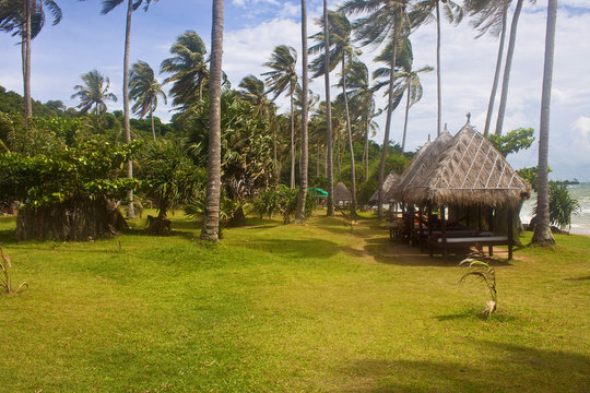 Tropical beach with huts on Koh Tonsay island, Cambodia