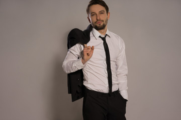 Handsome businessman loosening his tie