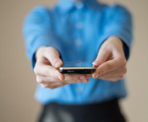Close up of woman holds  mobile smart phone in hands