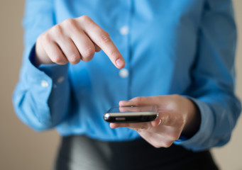 Close up of a woman using mobile smart phone