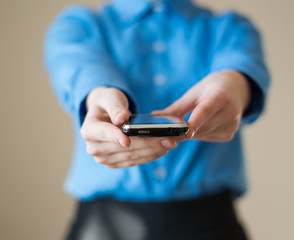 Close up of woman holds  mobile smart phone in hands
