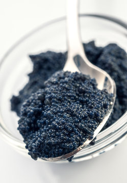 spoon with black caviar on bowl