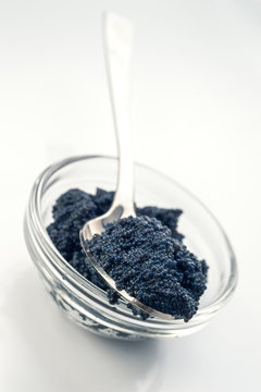 spoon with black caviar on bowl