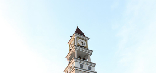Clock tower and light blue sky background.