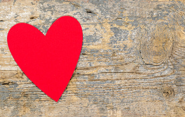 Red heart on a wooden table