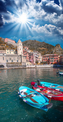 Colorful boats in the quaint port of Vernazza, Cinque Terre - It