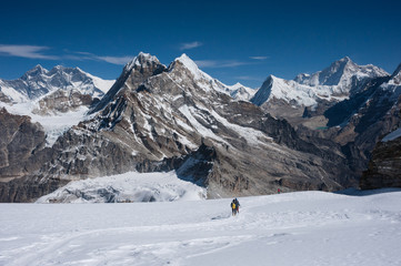 Fototapeta na wymiar Mountaineers walking on snow in Himalayas of Nepal