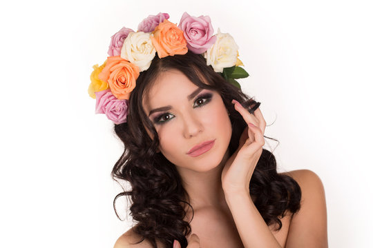 Beautiful young woman with floral wreath. Fashion shot. 
