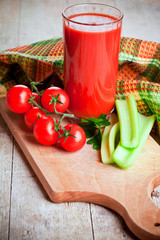 tomato juice in glass, fresh tomatoes and green celery