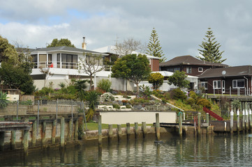 Fototapeta na wymiar Houses on waterfront in Milford, Auckland, New Zealand