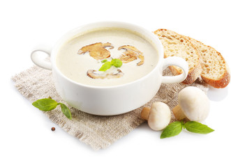 Mushroom soup in white bowl, on napkin, isolated on white