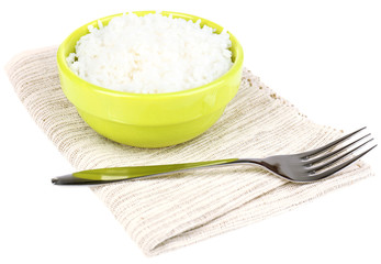 Cooked rice in bowl on napkin isolated on white