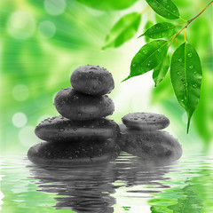Obraz na płótnie Canvas spa Background - black stones and bamboo on water