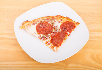 Slice of Pepperoni Pizza on White Plate