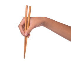 Female hand using chopstick over white background