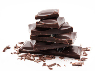 Dark chocolate bars stack with crumbs isolated on a white