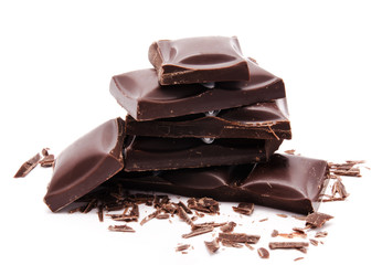 Dark chocolate bars stack with crumbs isolated on a white