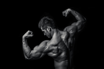 Fototapeta na wymiar Man with muscular torso isolated on black background, male tors