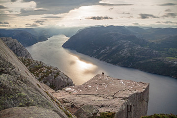 Silhouettes of two people on Pulpit Rock Preikestolen.
