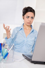 Business Frau in Blau - entsetzt und schockiert am Computer