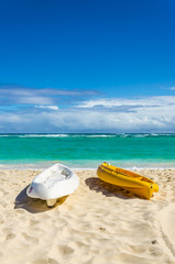 Kayaks on the beautiful sandy Caribbean beach in Dominikana - obrazy, fototapety, plakaty
