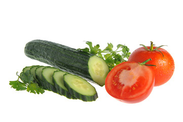 Sliced cucumber and tomatoes with green parsley isolated on whit
