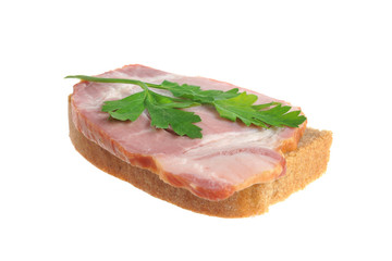 A ham sandwich with green leaf of parsley isolated on white