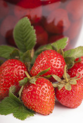 homemade strawberry jam in a glass jar and strawberry close up