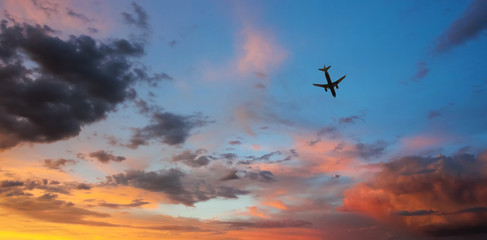 An Airliner Cruises Through a Sunset Sky