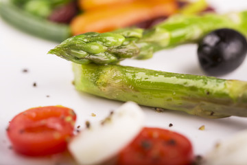 Salad from asparagus with cherry tomato, cheese and vegetables