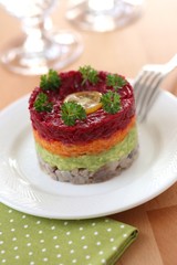 Herring appetizer with beetroot, carrot and avocado