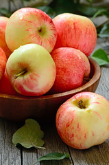 Red ripe apples on wooden table