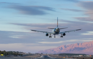 Fototapeta na wymiar Airplane is landing to airport of Eilat-famous resort in Israel