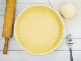 Tart / quiche dough (shortcrust pastry) in ceramic baking form
