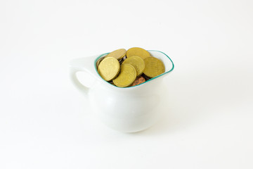 Coin in cup on white background