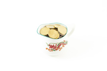 Coin in cup on white background
