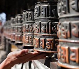 many prayer wheels and hand