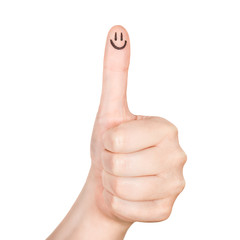 Female hand shows thumbs up with smile face on the finger .