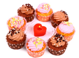 Chocolate and pink cup cakes with candle heart
