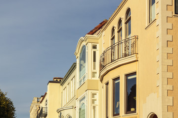 A row of upscale houses with roof and cornice detail