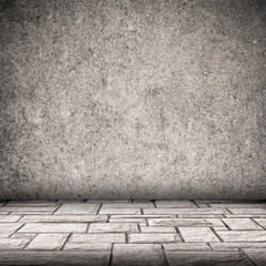 Gray concrete wall and brick floor interior