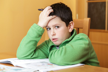 bored and tired boy doing homework