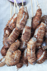 Taro cooked skewers on the market.