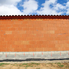 Mur en briques rouges sur fondations