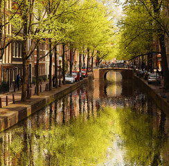 Amsterdam city with green canal in Holland