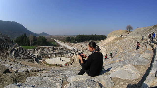 tourist use digital tablet in amphitheather of ancient Ephesus