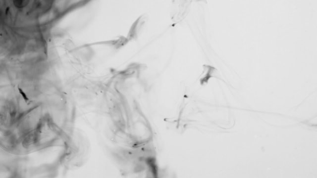 Ink blots are falling and spreading in water.